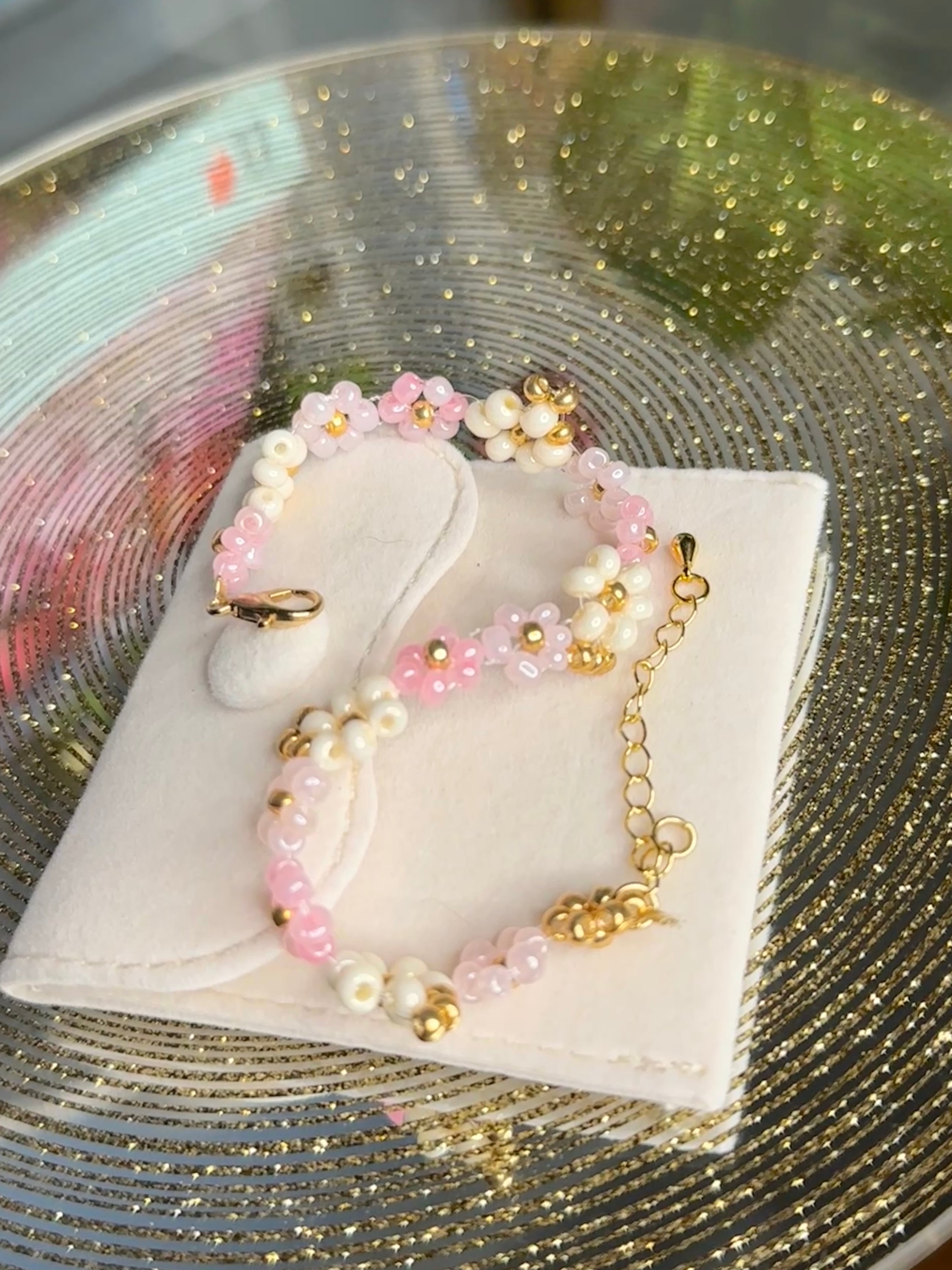 pink floral beaded bracelet with gold accents